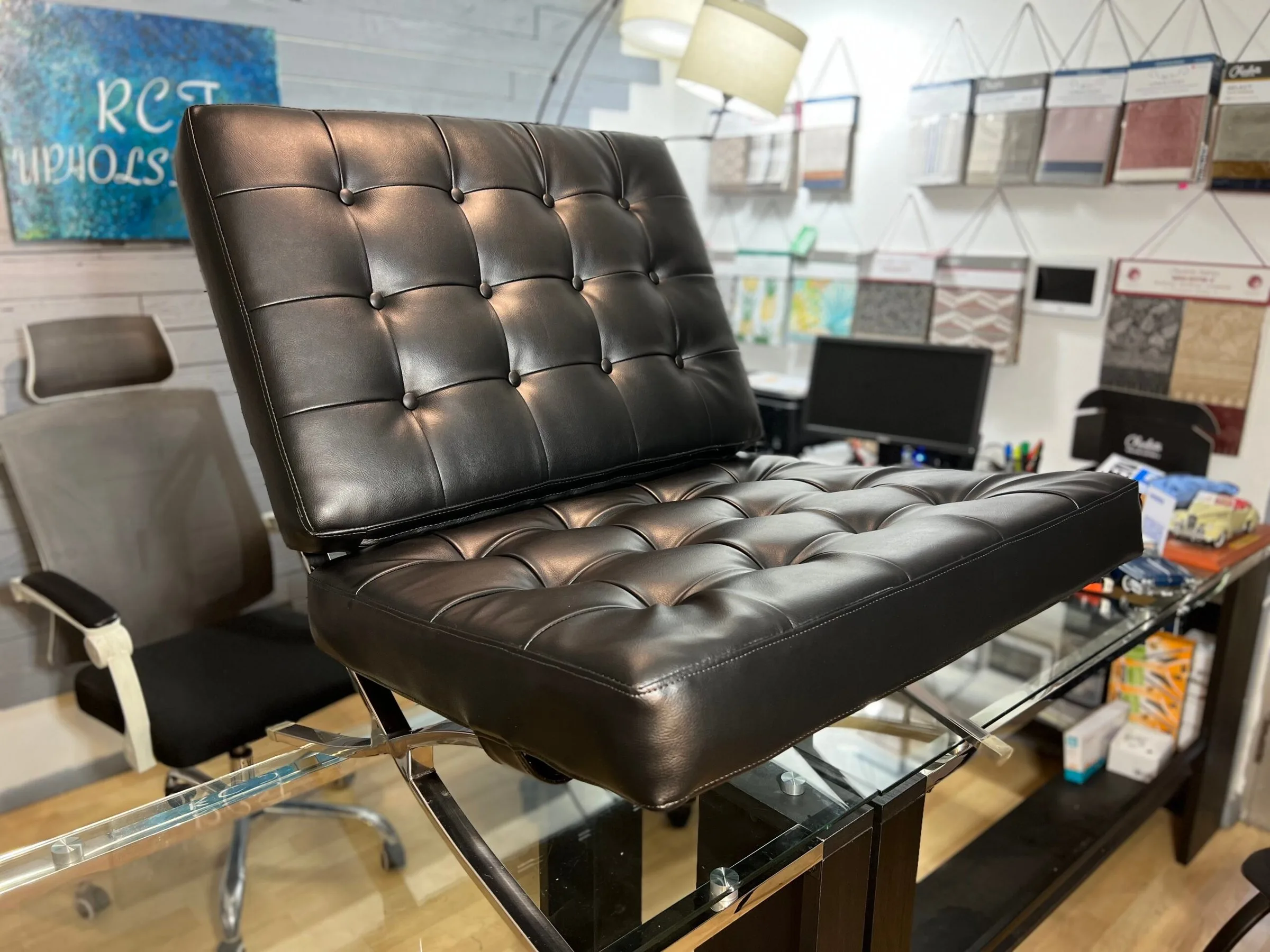 Black leather tufted Barcelona chair reupholstered by RCT