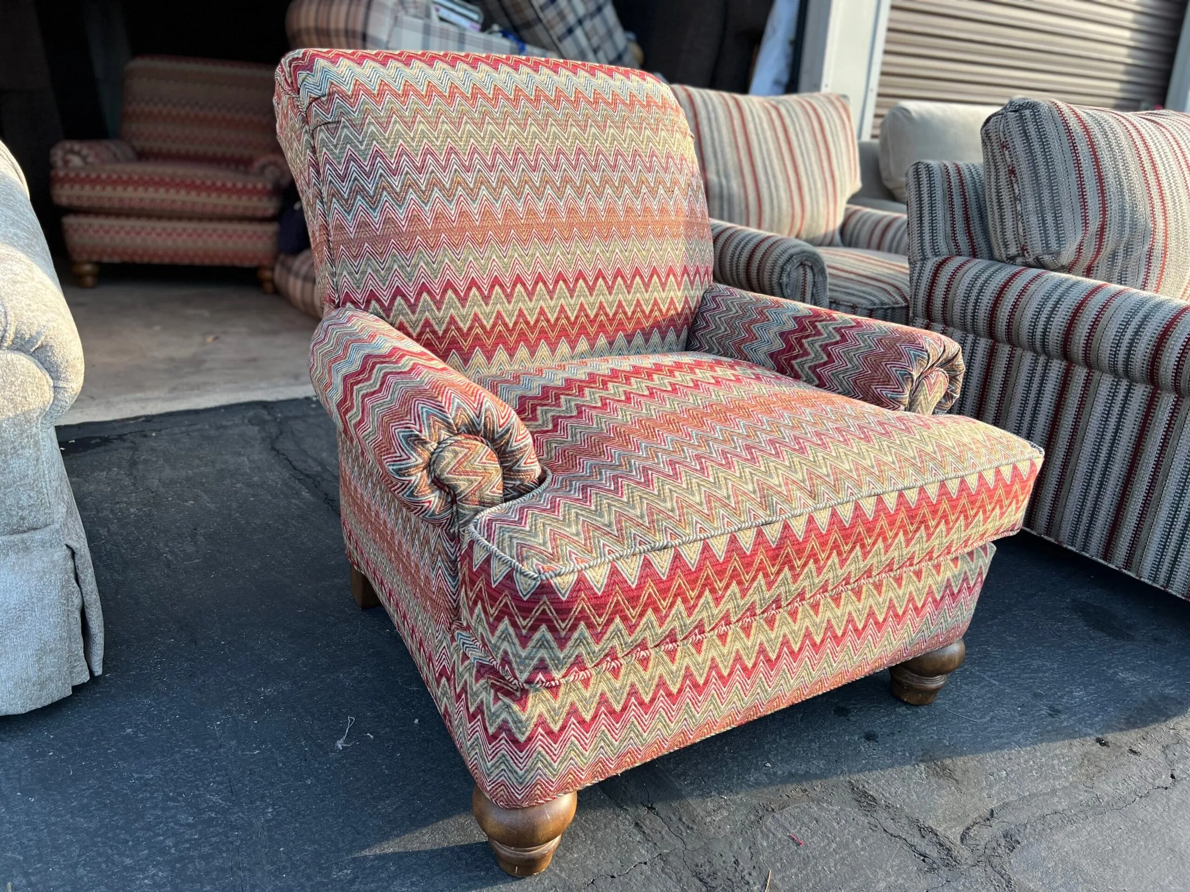 Traditional armchair reupholstered in vibrant multi-color chevron fabric